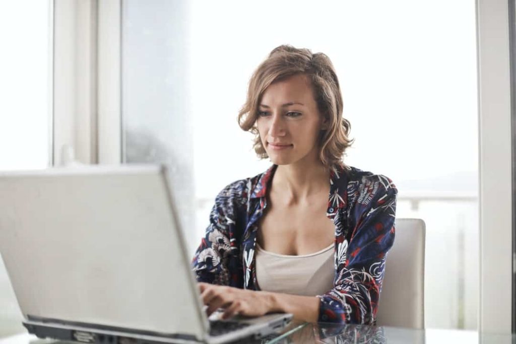 A woman at her laptop, exploring the backlinks to her website