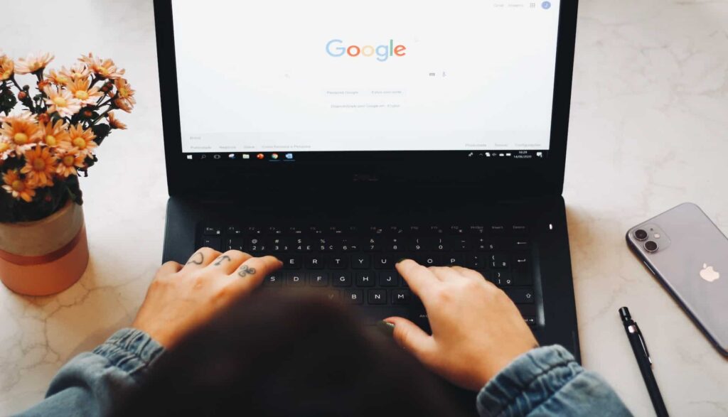 woman on Google on black laptop